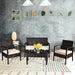 4-Piece Outdoor Patio Rattan Conversation Set with Loveseat, 2 Single Sofas & Glass Table arranged in a stylish indoor setting, featuring cushions and decorative items.