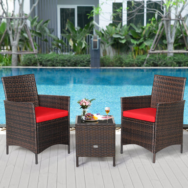 3-Piece Red Cushioned Patio Rattan Furniture Set with Glass Tabletop for Outdoor Living, featuring two rattan chairs with red cushions and a glass-topped table, set beside a sparkling pool.