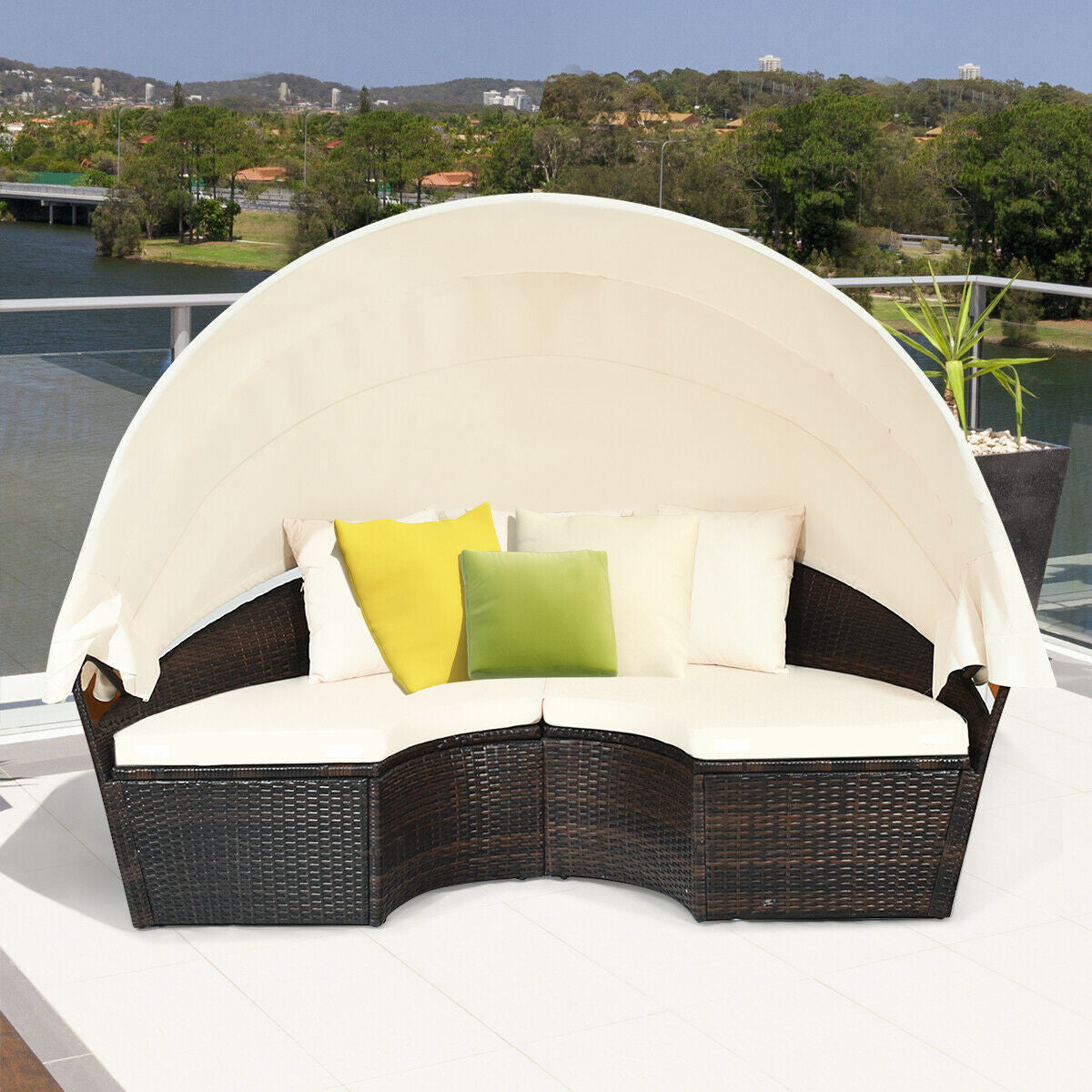Spacious 5-Piece Patio Round Daybed Set with Canopy, Cushions & Adjustable Coffee Table from Dream Yard Oasis ™, displayed on a balcony with comfy cushions and a protective canopy.