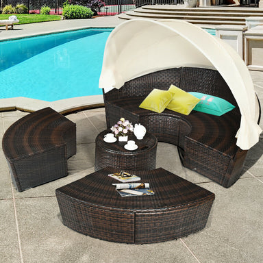 Spacious 5-Piece Patio Round Daybed Set with Canopy, Cushions & Adjustable Coffee Table from Dream Yard Oasis ™, featuring a stylish wicker design by a poolside with soft cushions and a retractable canopy.