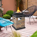 Elevate your patio with the 40,000 BTU Outdoor Propane Fire Bowl Column. Stylish fire bowl on a wooden deck, showcasing its brown stacked stone design.