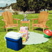 3-Piece Eucalyptus Adirondack Chair Set with Widened Armrests and Convenient Side Table, featuring two chairs and a side table on a sunny grassy area by a beach.