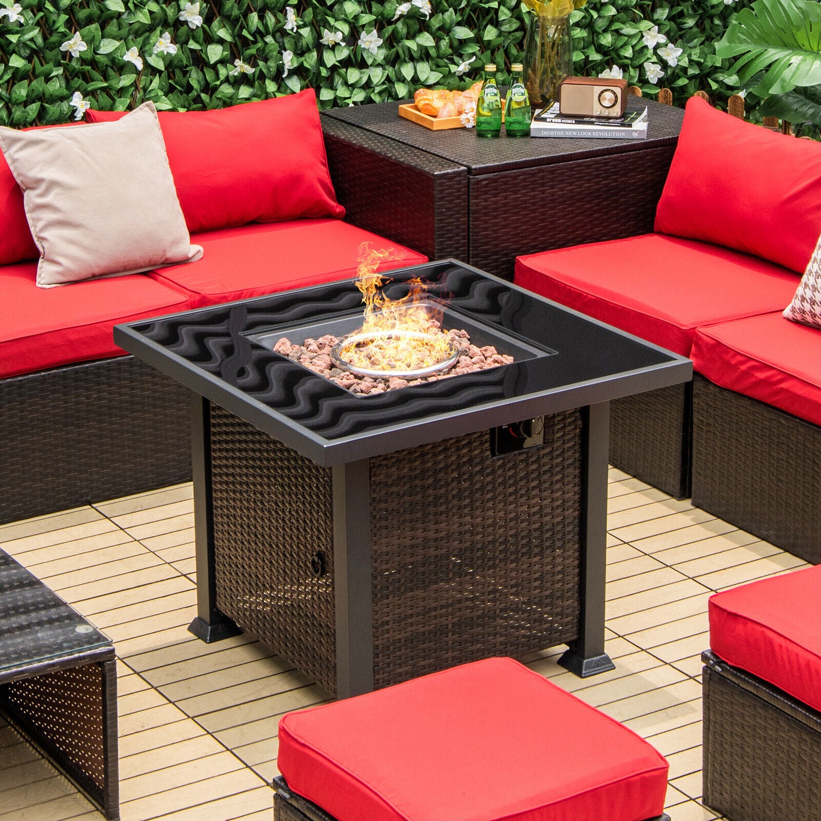 The 32-Inch Square Propane Fire Pit Table with Lava Rocks displaying a vibrant fire surrounded by seating, showcasing its functionality.