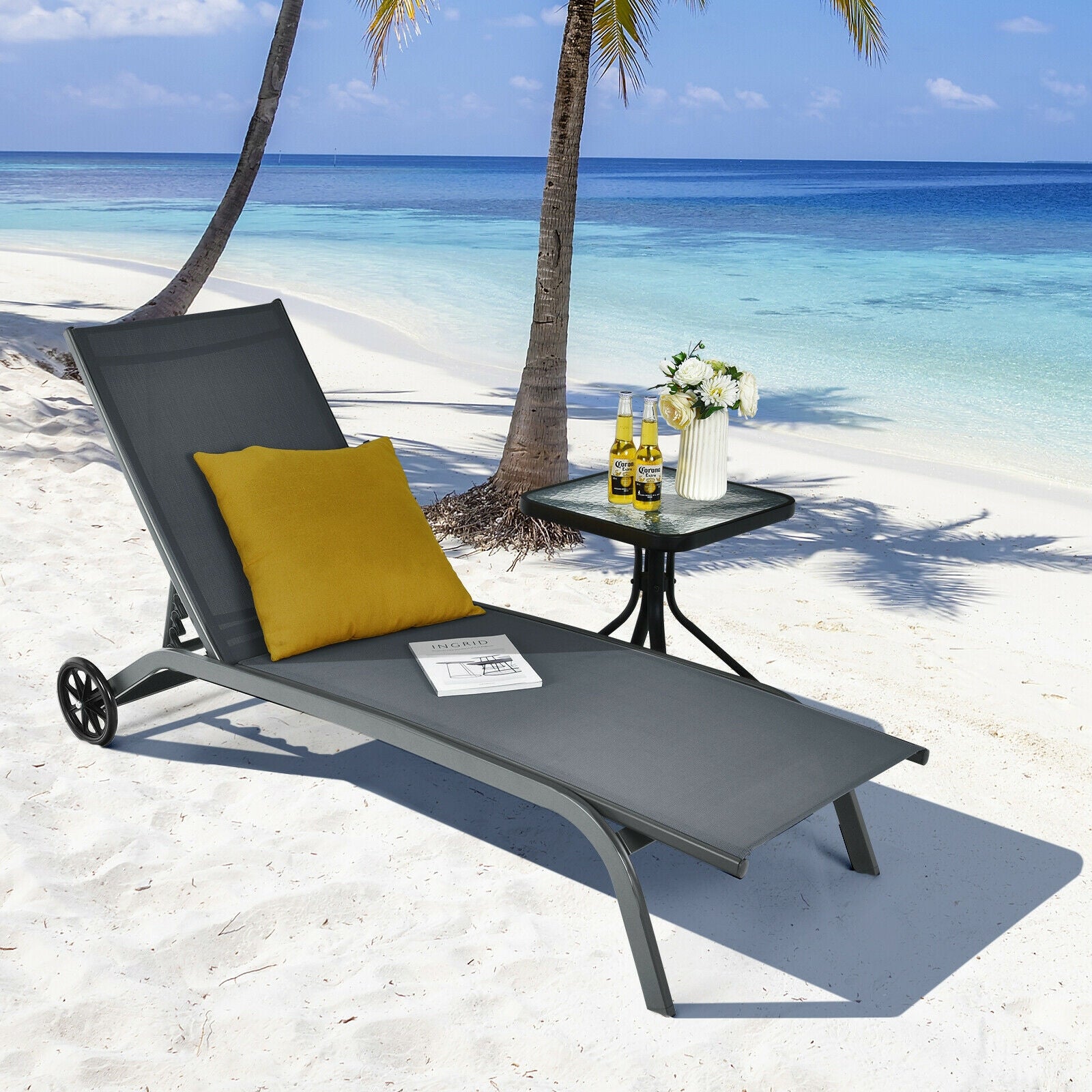Enjoy the sun by the beach on the 6-Position Adjustable Outdoor Chaise Lounge Chair with Wheels, showcased with a yellow pillow and drinks, perfect for relaxation.