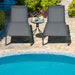 Two 6-Position Adjustable Outdoor Chaise Lounge Chairs with Wheels arranged by a pool, illustrating stylish outdoor seating and comfort with a side table.