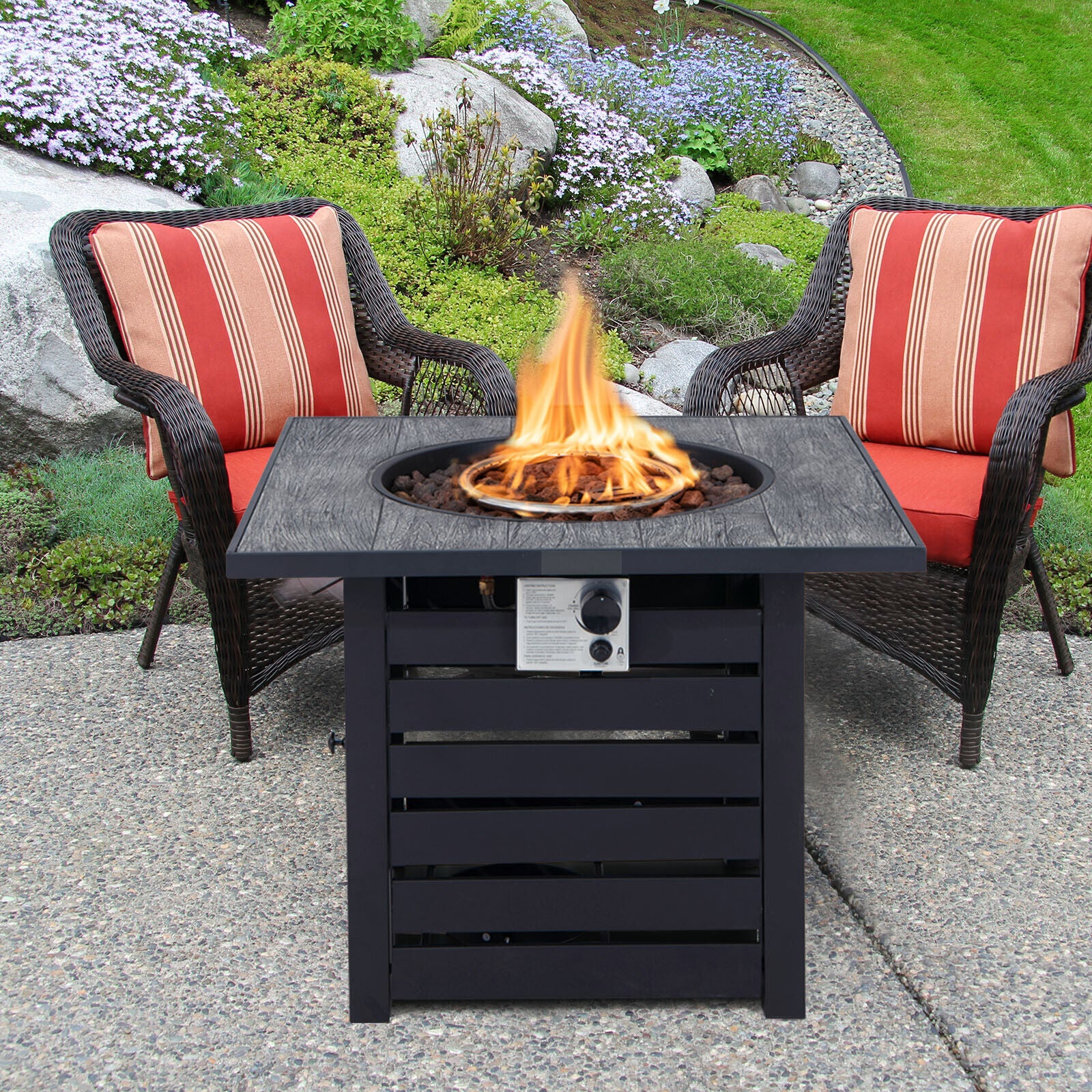 The 32" Square Propane Fire Pit Table with 50,000 BTU enhancing a backyard patio setup, perfect for relaxation.