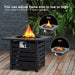 Close-up view of the 32" Square Propane Fire Pit Table with adjustable flame sizes, showcasing the ignition control feature among lush greenery.