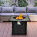 32-Inch Propane Fire Pit Table with Lava Rocks, 50000 BTU, CSA Certified, Black featuring flames surrounded by volcanic rocks in a backyard setting with outdoor seating.