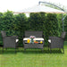 4-Pc Outdoor Patio Rattan Sofa Set with Cushions showcased in a green garden, featuring a stylish white loveseat, two single chairs, and a glass coffee table perfect for outdoor gatherings.