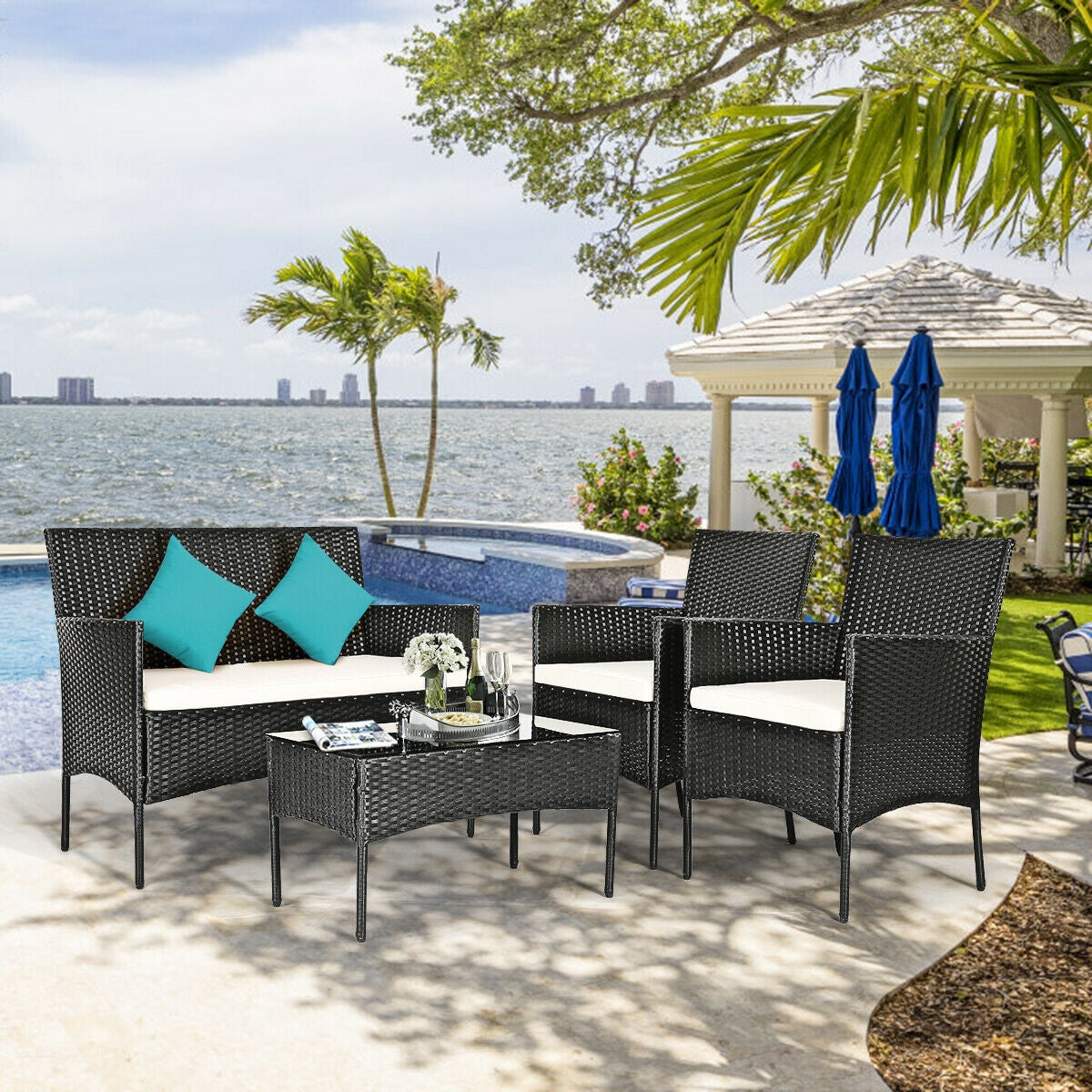 4-Pc Outdoor Patio Rattan Sofa Set with Cushions arranged by a pool, highlighted with turquoise cushions and scenic outdoor views.