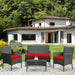 4 Piece Red Patio Rattan Sofa Set with Cushions & Glass Table displayed in a backyard setting, featuring weather-resistant materials ideal for outdoor relaxation.