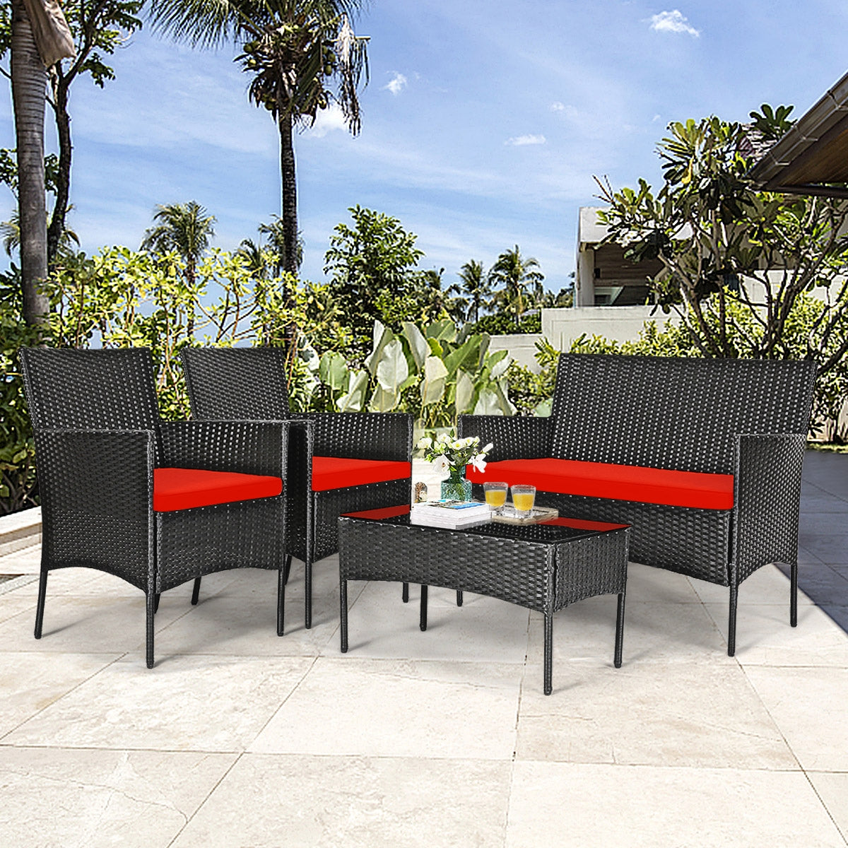 Stylish 4 Piece Red Patio Rattan Sofa Set with Cushions & Glass Table, positioned in a sunny patio environment, perfect for relaxation.