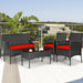 4 Piece Red Patio Rattan Sofa Set with Cushions & Glass Table set on a modern balcony with a view, showcasing stylish rattan chairs and a loveseat, great for outdoor gatherings.