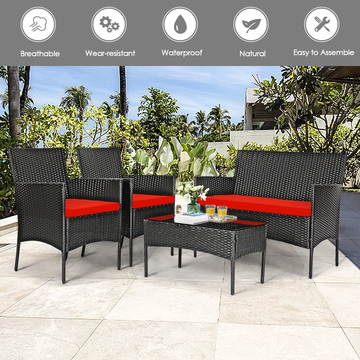 4 Piece Red Patio Rattan Sofa Set with Cushions & Glass Table displayed in a beautiful outdoor setting, featuring breathable and weather-resistant materials.