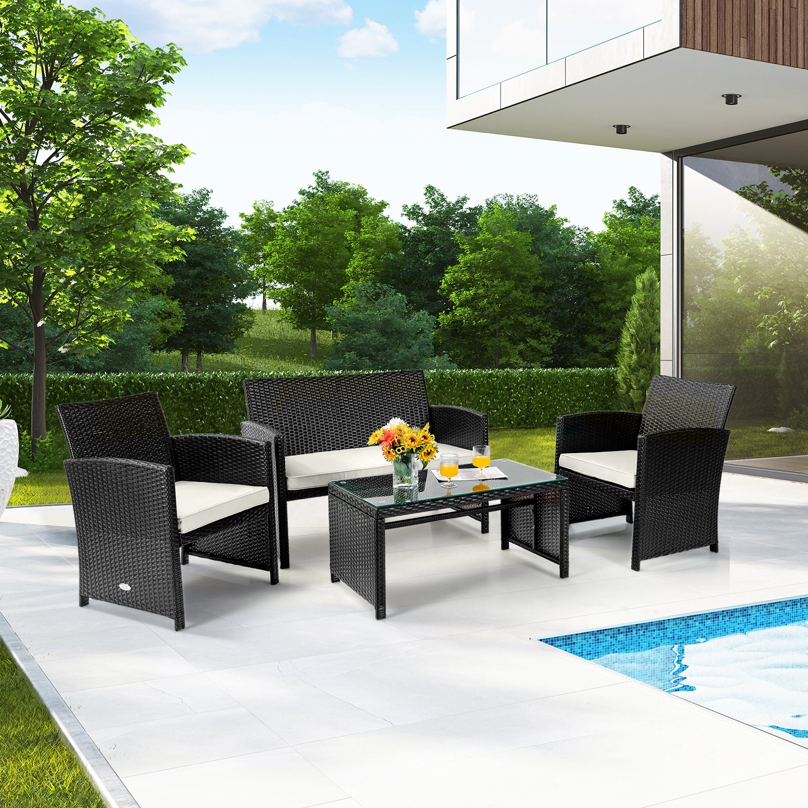 Stylish 4-Piece Weather-Resistant Rattan Patio Seating Set positioned outdoors with a pool view, featuring stylish black rattan and white cushions.