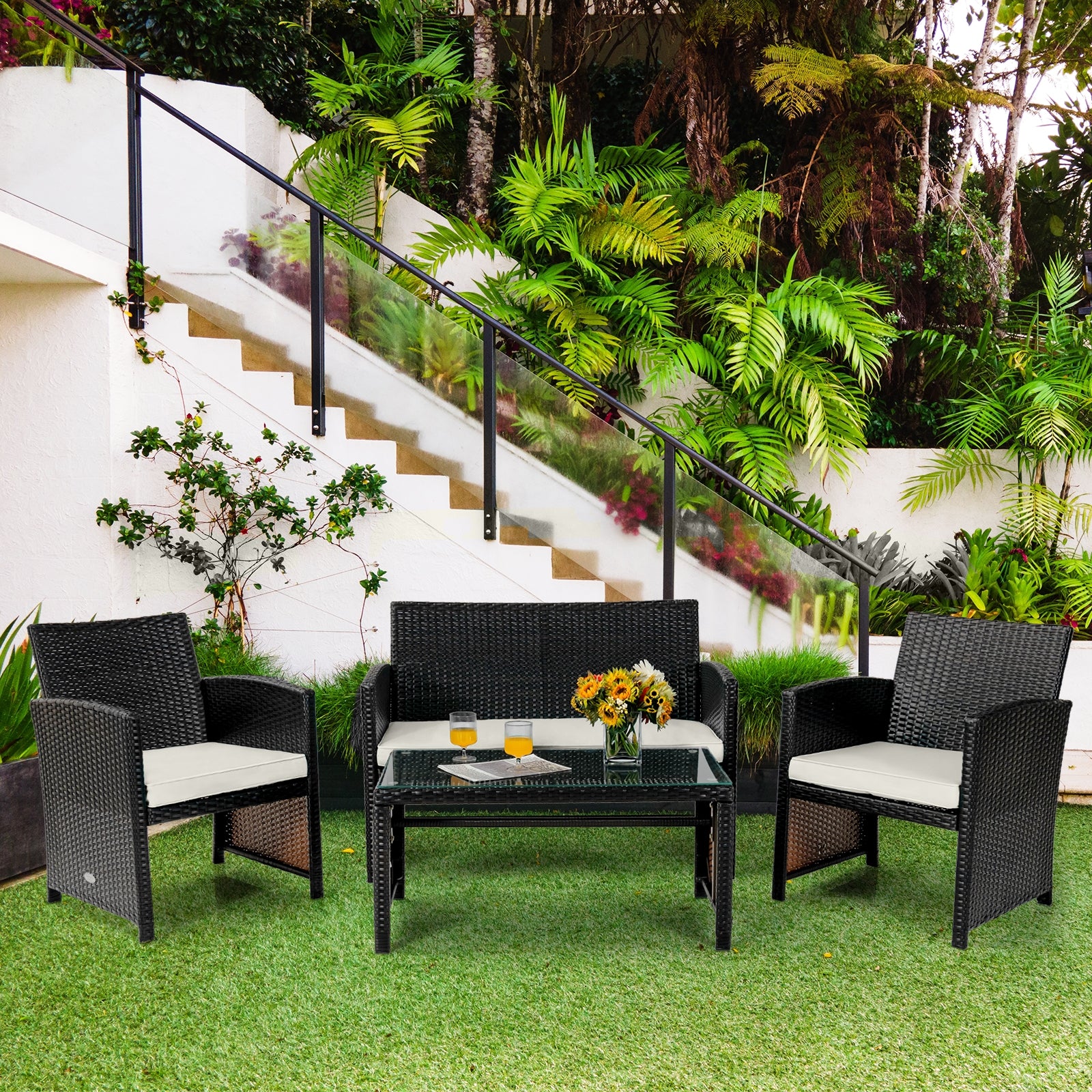 Vibrant setup of the 4-Piece Weather-Resistant Rattan Patio Seating Set surrounded by lush greenery, adding charm to any outdoor space.