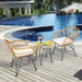 3-Piece White Rattan Furniture Set with Cushioned Chairs and Glass Top Table for Outdoor Relaxation, placed by a poolside, featuring two elegant rattan chairs and a stylish glass-top coffee table with drinks and decor.