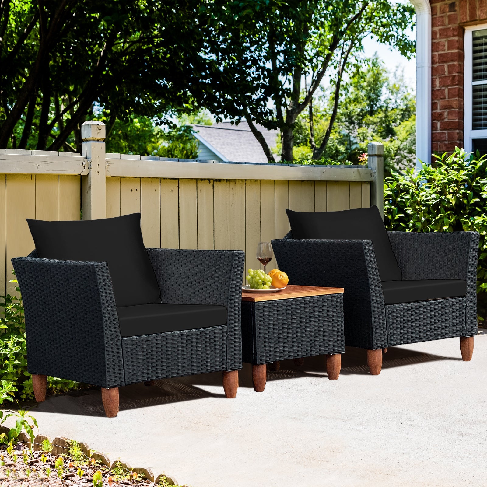 3-Piece Black Rattan Patio Furniture Set with Plush Cushions & Rustic Wood Coffee Table placed in a backyard, ideal for relaxation.