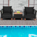 3-Piece Black Rattan Patio Furniture Set with Plush Cushions & Rustic Wood Coffee Table, designed for poolside relaxation with two black chairs and a table, surrounded by a swimming pool.