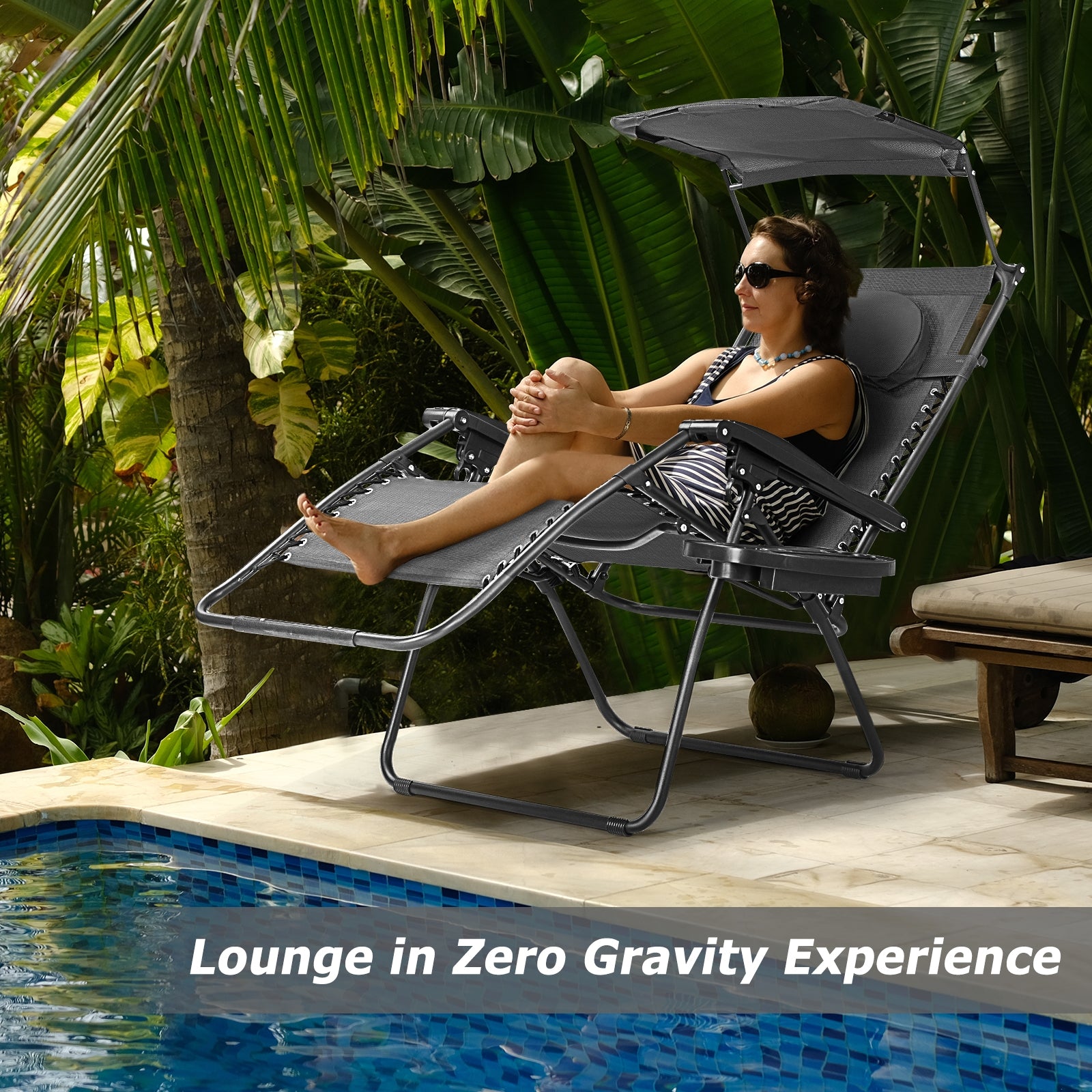 Woman lounging in a Folding Recliner Lounge Chair with Adjustable Shade Canopy & Cup Holder by Dream Yard Oasis, enjoying a zero gravity experience by the pool.