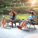Folding Recliner Lounge Chair With Adjustable Shade Canopy & Cup Holder - Coffee, perfect for enjoying a sunny day. A man and woman relax in stylish chairs, featuring adjustable canopies, on a sunny deck.