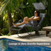 A woman lounging in a Dream Yard Oasis Folding Recliner Lounge Chair with Canopy by the pool, showcasing zero gravity experience and comfort.