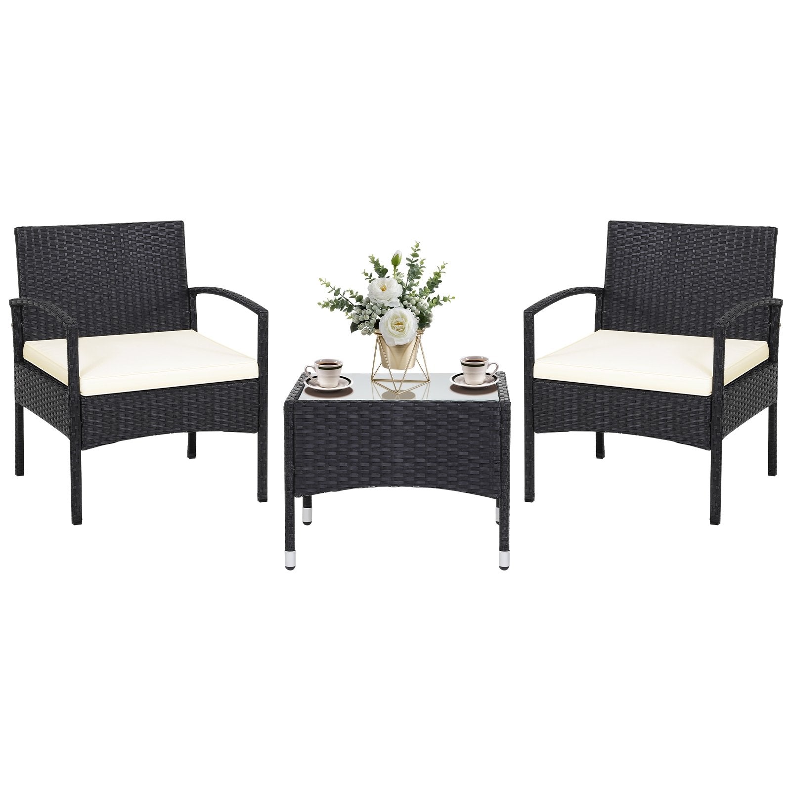 Elegant arrangement of the 3-Piece Patio Wicker Rattan Furniture Set with decorative items on the glass table, enhancing outdoor aesthetics.