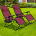 Two 2-Piece Wine Zero Gravity Folding Lounge Chairs positioned on a green lawn, perfect for outdoor lounging and social gatherings.