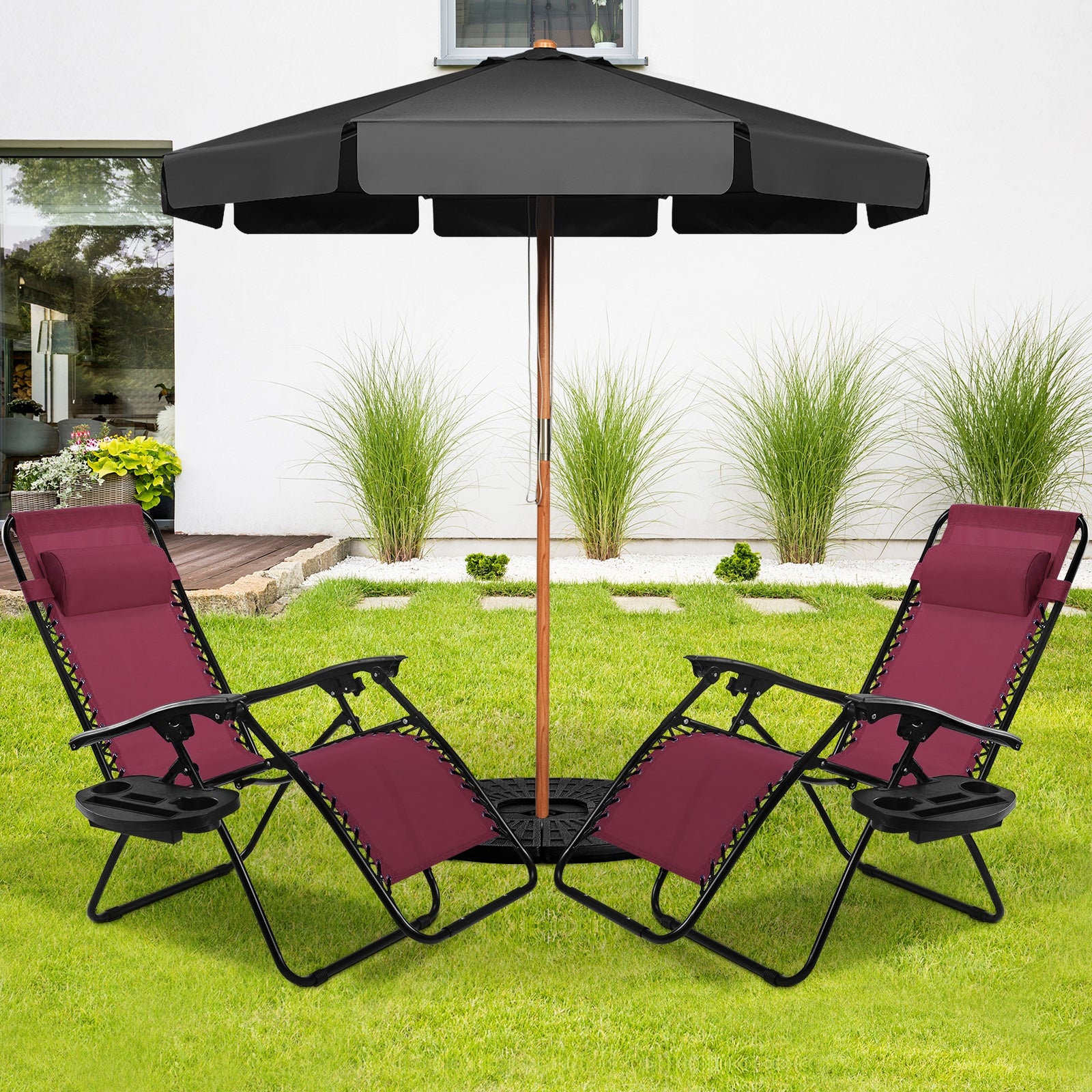 2-Piece Wine Zero Gravity Folding Lounge Chairs under a black umbrella in a backyard setting, ideal for enjoying the outdoors.
