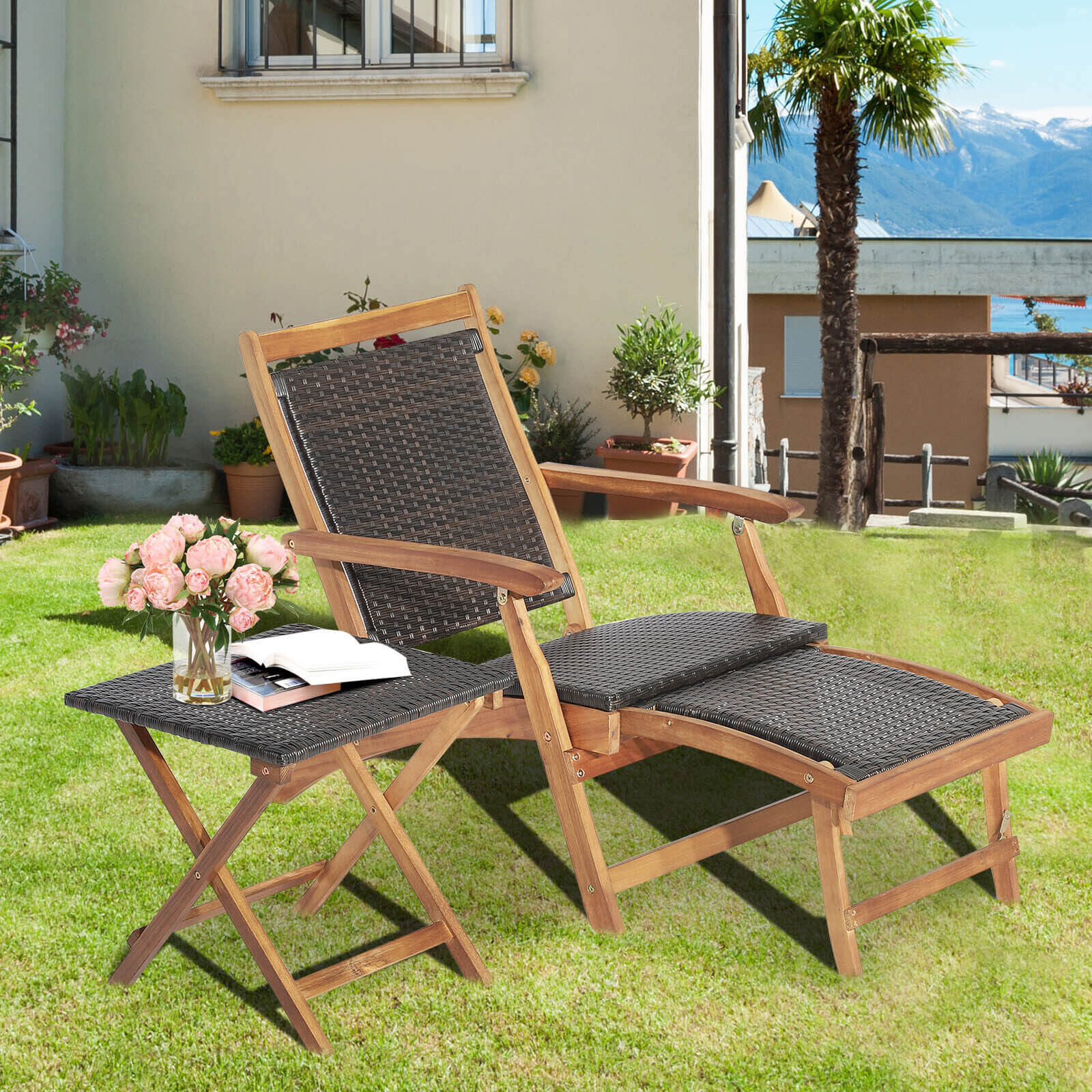 2 Pieces Patio Rattan Folding Lounge Chair with Acacia Wood Table displayed in an outdoor garden setting, featuring pink flowers and a book on the side table.
