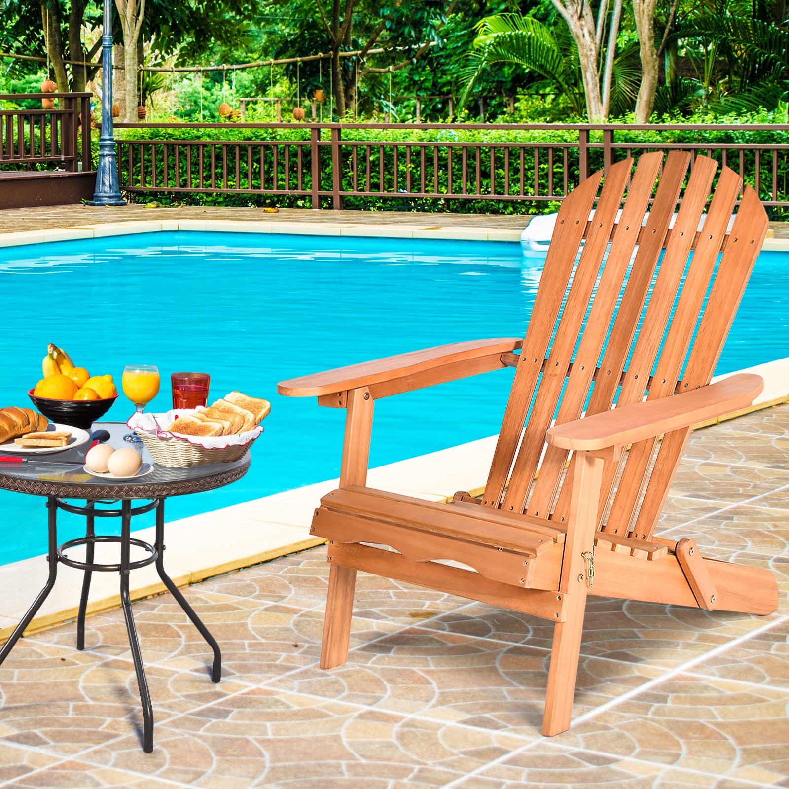 Eucalyptus Foldable Outdoor Adirondack Chair with Ergonomic Design and Comfort for Patio, Deck, Garden beside a pool with a breakfast spread.