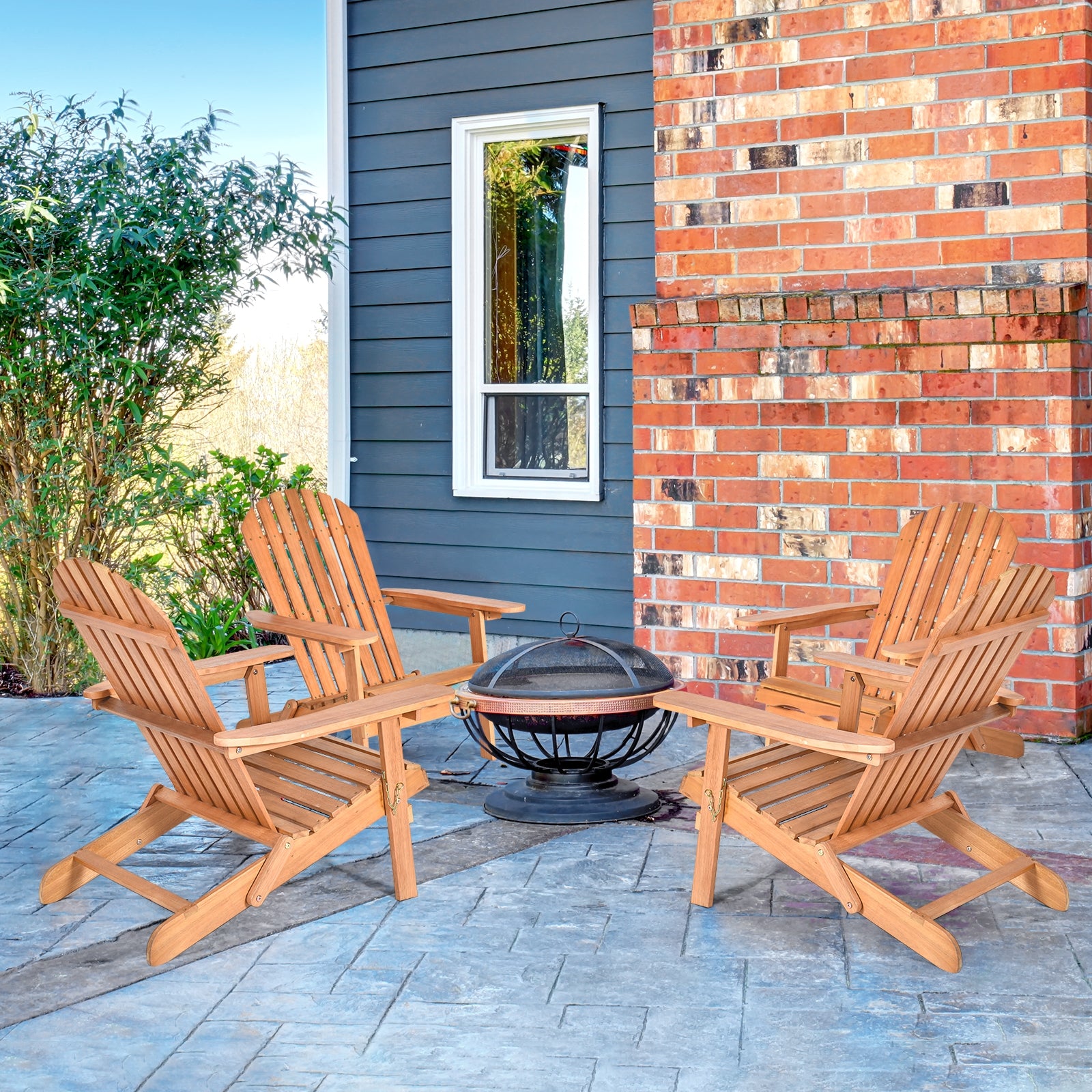 Eucalyptus Foldable Outdoor Adirondack Chair set around a fire pit on a stylish patio. Perfect for relaxation in your garden or deck.