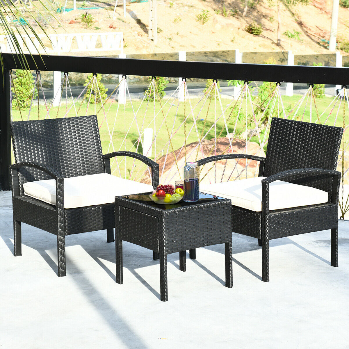 3 Piece Outdoor Rattan Sofa Set with Cushions and Glass Table for Patio and Garden arranged on a balcony with drinks and fruit, perfect for outdoor entertaining.