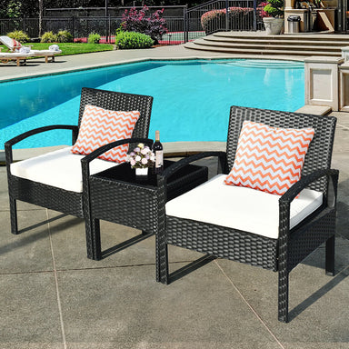 3 Piece Outdoor Rattan Sofa Set with Cushions and Glass Table for Patio and Garden featuring stylish chairs with orange chevron pillows, set by a poolside.