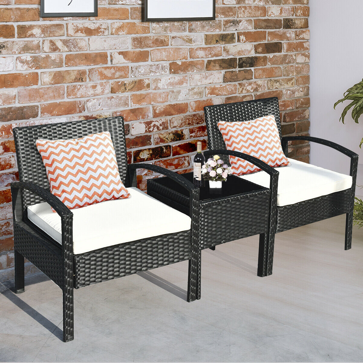 Stylish interior setting with the 3 Piece Outdoor Rattan Sofa Set with Cushions and Glass Table for Patio and Garden, featuring decorative pillows and a cozy ambiance.