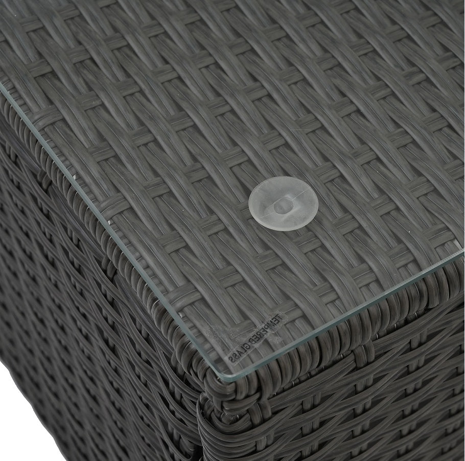 Detail view of the textured wicker and glass top on the coffee table of the 7-Piece Patio Furniture Set, showcasing modern elegance.
