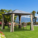 Outsunny 10X10 Ft Hard Top Gazebo Canopy in a beautiful backyard setting, perfect for outdoor gatherings with a spacious design and comfortable seating.
