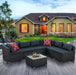 7-Piece Patio Furniture Set with Tempered Glass Coffee Table featuring dark gray PE wicker and comfortable cushions, ideal for outdoor gatherings, set in a beautiful garden setting.