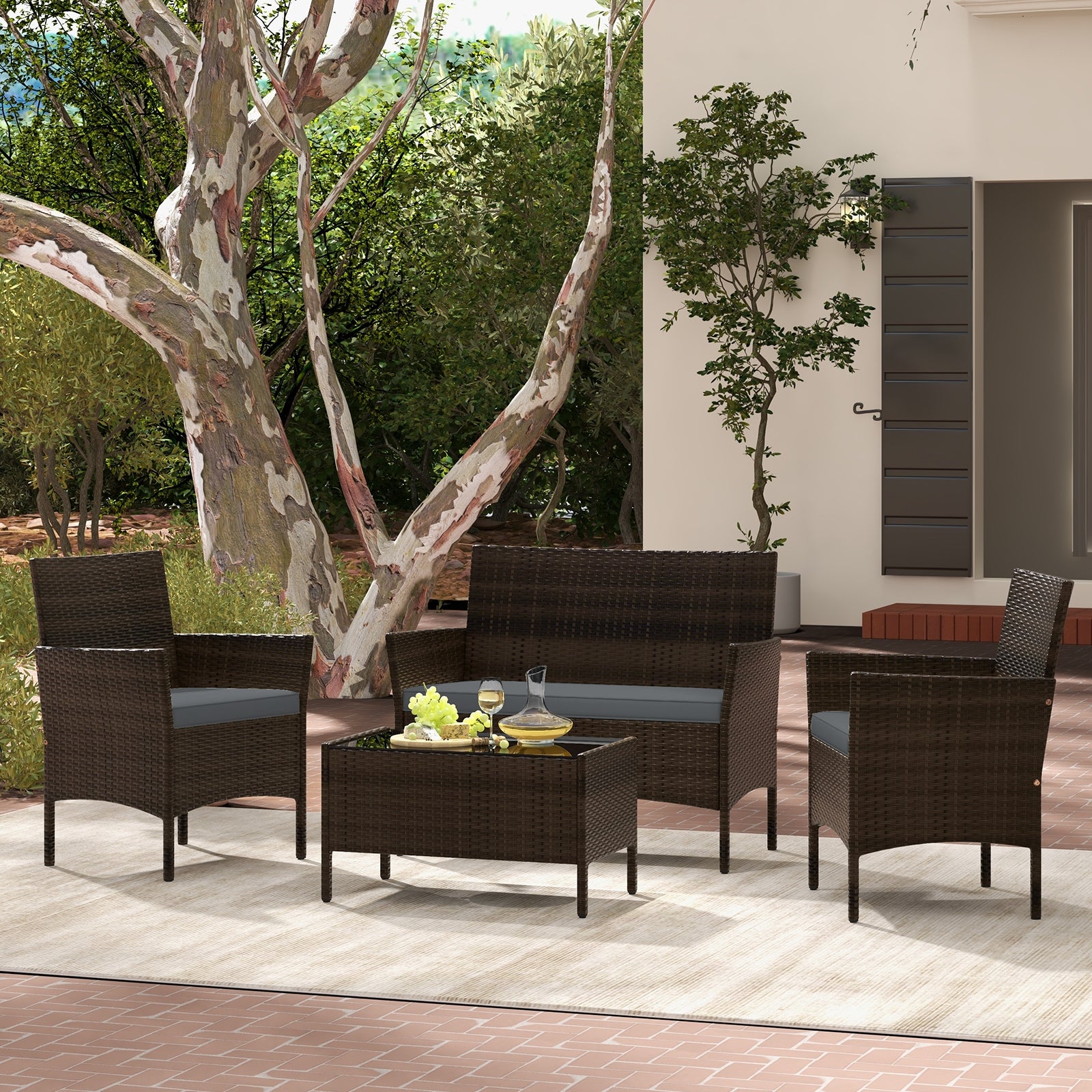 4-Piece Gray Patio Rattan Conversation Set with Comfortable Cushions & Sturdy Design, featuring stylish chairs and a coffee table set in a lush outdoor setting.