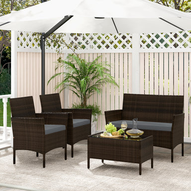 4-Piece Gray Patio Rattan Conversation Set with Comfortable Cushions & Sturdy Design, arranged under a stylish umbrella with decorative plants in a cozy outdoor space.