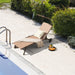 Heavy-Duty Adjustable Chaise Lounge Chair with Canopy & Cup Holder featuring a brown fabric seat by the poolside, adorned with a decorative pillow and a cozy throw blanket, perfect for leisure and relaxation.